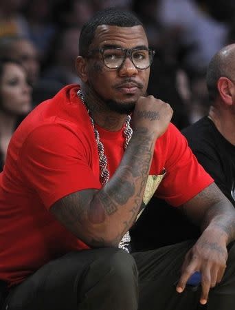 Rapper Jayceon Terrell Taylor, known by his stage name "Game" and "The Game", sits courtside as he watches the Los Angeles Lakers play the Houston Rockets during their NBA basketball game in Los Angeles, California, November 18, 2012. REUTERS/Alex Gallardo
