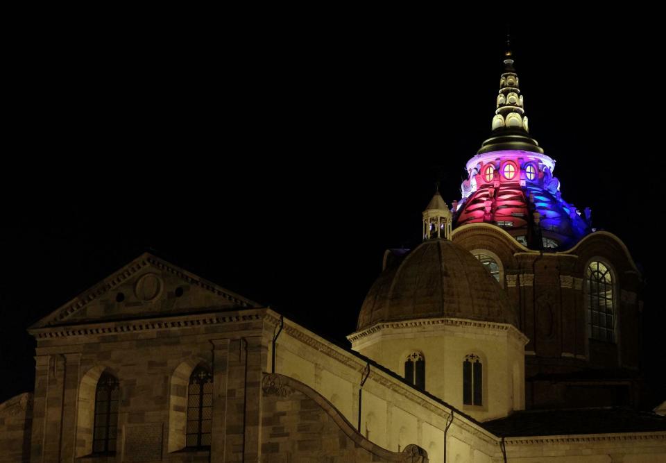 The dome of the Chapel of the Shroud is illuminated with the colors of the French flag in Turin, Italy, Tuesday, April 16, 2019. The Archbishop of Turin says that the Notre Dame fire brought back painful memories of the 1997 blaze that tore through the chapel that is home to the Shroud of Turin. Monsignor Cesara Nosiglia on Tuesday recalled the dramatic events of April 11, 1997 when firemen rescued the shroud, venerated as the holy cloth in which Jesus was wrapped after his crucifixion, from its bulletproof, climate-controlled glass case.(Alessandro Di Marco/ANSA via AP)