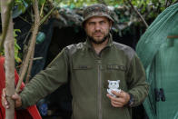 Ukrainian soldier Vyacheslav Timohovich holds the stuffed owl toy his seven-year-old daughter gave him to keep him safe as he serves with the Dnipro-1 regiment near Sloviansk, Donetsk region, eastern Ukraine, Friday, Aug. 5, 2022. Timohovich, who goes by the nickname "Owl," always keeps the stuffed toy from his daughter tucked inside his body armor. (AP Photo/David Goldman)