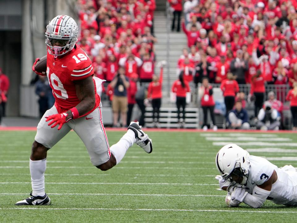 Oct 21, 2023; Columbus, Ohio, USA; Ohio State Buckeyes running back Chip Trayanum (19) carries the ball after a catch and gets past Penn State Nittany Lions cornerback Johnny Dixon (3) during the first quarter of their game at Ohio Stadium.