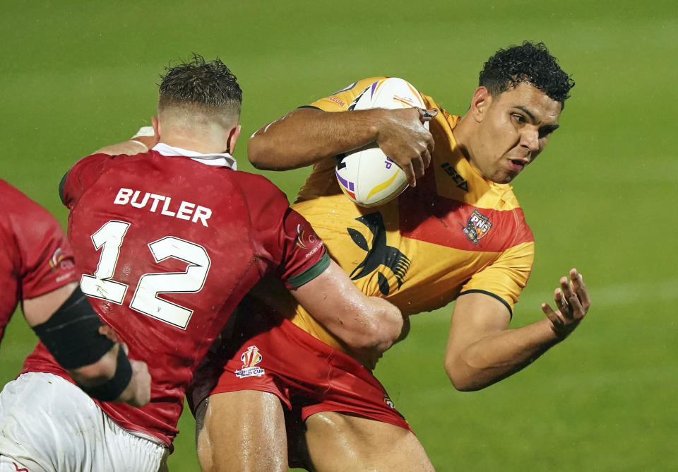 Papua New Guinea's Jacob Alick, right, is tackled by Wales' Chester Butler during the Rugby League World Cup group D match between Wales and Papua New Guinea at the Eco-Power Stadium, Doncaster, England, Monday Oct. 31, 2022. (Tim Goode/PA via AP)