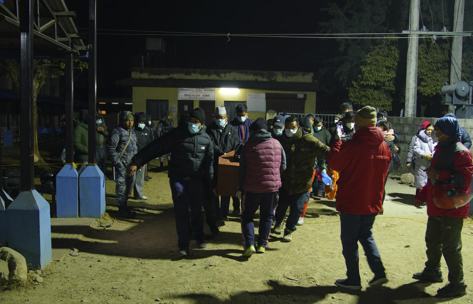 The body of a victim of Sunday's plane crash is carried out of a morgue in Pokhara, Nepal, Monday, Jan 16, 2023. At least 69 of the 72 people aboard were killed, and officials believe the three missing are also dead. Rescuers combed through the debris, scattered down a 300-meter-deep (984-foot-deep) gorge, for them. (AP Photo/Yunish Gurung)