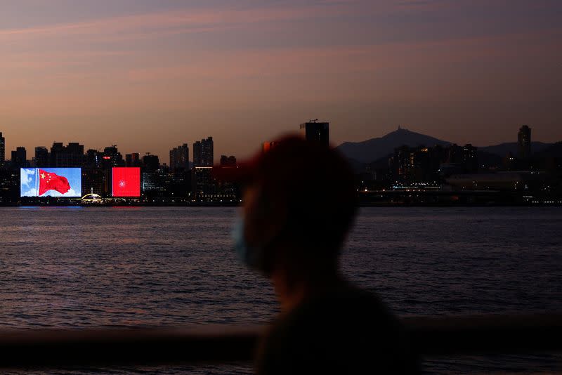 FILE PHOTO: The Chinese flag is seen across the Victoria Harbour during sunset, in Hong Kong