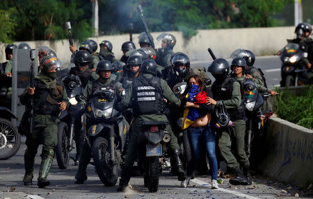 A demonstrator is detained by security forces during clashes at a protest against Venezuelan President Nicolas Maduro's government in Caracas. REUTERS/Carlos Garcia Rawlins