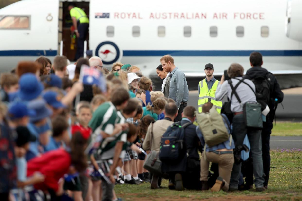 Prince Harry, Duke of Sussex, and Meghan, Duchess of Sussex, meet waiting public as they arrive at Dubbo Airport: Getty Images