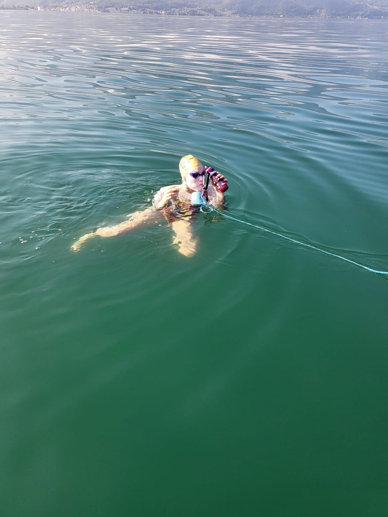 Sam Farrow treading water while drinking