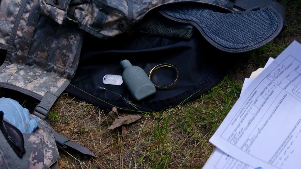 Personal effects of a recovered Soldier is placed on the ground to be listed after search and recovery operations on a downed helicopter during the 2015 Mortuary Affairs Exercise at Fort Pickett, Va., May 28, 2015. The Mortuary Affairs Exercise is the first of its kind, bringing together five Army Reserve mortuary affairs units and one active duty mortuary affairs unit to train together and share their knowledge. (U.S. Army photo by Brian Godette/Released)