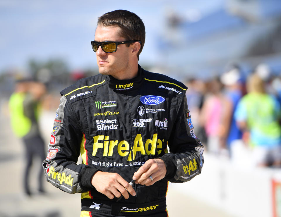 BROOKLYN, MICHIGAN - AUGUST 09: David Ragan, driver of the #38 MDS Transport Ford, walks to his car during qualifying for the Monster Energy NASCAR Cup Series Consumers Energy 400 at Michigan International Speedway on August 09, 2019 in Brooklyn, Michigan. (Photo by Quinn Harris/Getty Images)