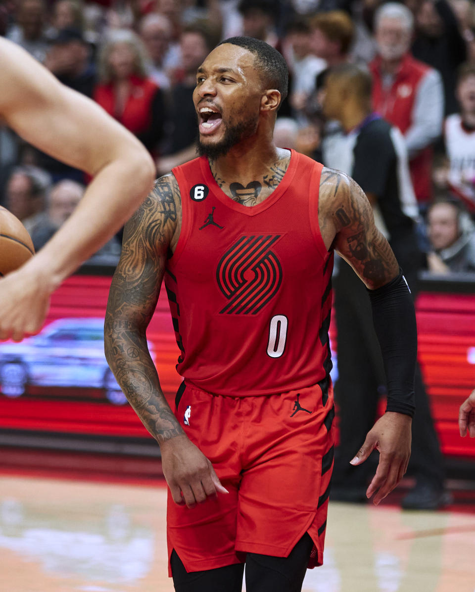 Portland Trail Blazers guard Damian Lillard reacts after a missed shot by center Deandre Ayton during overtime in an NBA basketball game in Portland, Ore., Friday, Oct. 21, 2022. (AP Photo/Craig Mitchelldyer)
