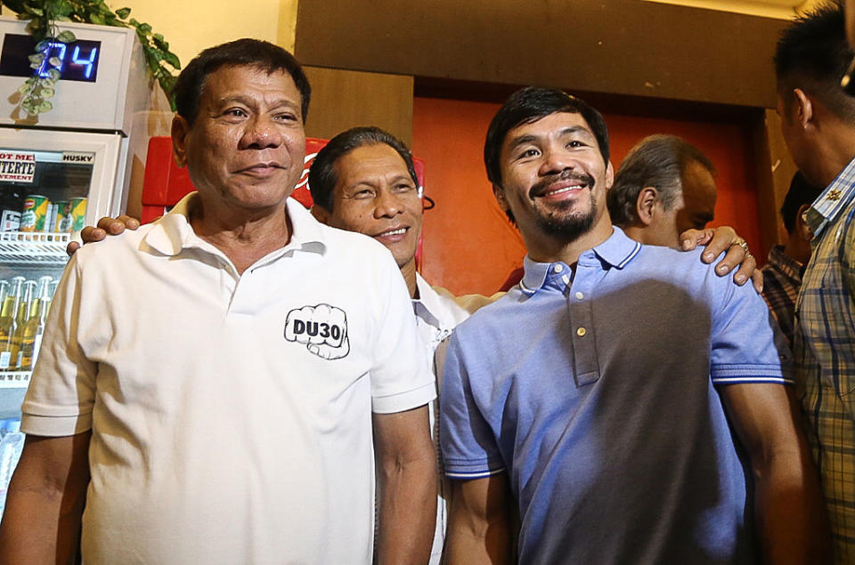 Philippines' President Rodrigo Duterte (L) stands beside boxing icon and Senator Manny Pacquiao (R) at a meeting in Davao in southern island of Mindanao on May 28, 2017.<span class="copyright">Manman Dejeto-AFP/Getty Images</span>