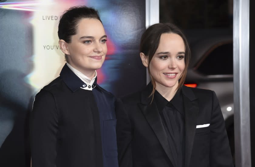 FILE - Emma Portner, left, and Ellen Page arrive at the world premiere of "Flatliners" on Sept. 27, 2017, in Los Angeles. Page and Portner say they are divorcing after three years of marriage. In a statement Tuesday, Jan. 26, 2021, the couple said "we have made the difficult decision to divorce following our separation last summer." Portner was vocal in her support of Page when he came out as transgender in December, an announcement greeted as a watershed moment for the trans community in Hollywood. (Photo by Richard Shotwell/Invision/AP, File)