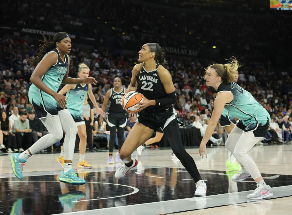 LAS VEGAS, NEVADA – OCTOBER 4: A'ja Wilson #22 of the Las Vegas Aces drives to the basket against Jonquel Jones #35 and Sabrina Ionescu #20 of the New York Liberty during the second quarter of Game 3 of the 2024 WNBA Playoffs at the Michelob ULTRA Arena on October 4, 2024 in Las Vegas, Nevada. The Aces defeated the Liberty 95-81. NOTE TO USER: User expressly acknowledges and agrees that by downloading and/or using this photograph, User is agreeing to the terms and conditions of the Getty Images License Agreement. (Photo by Ethan Miller/Getty Images)