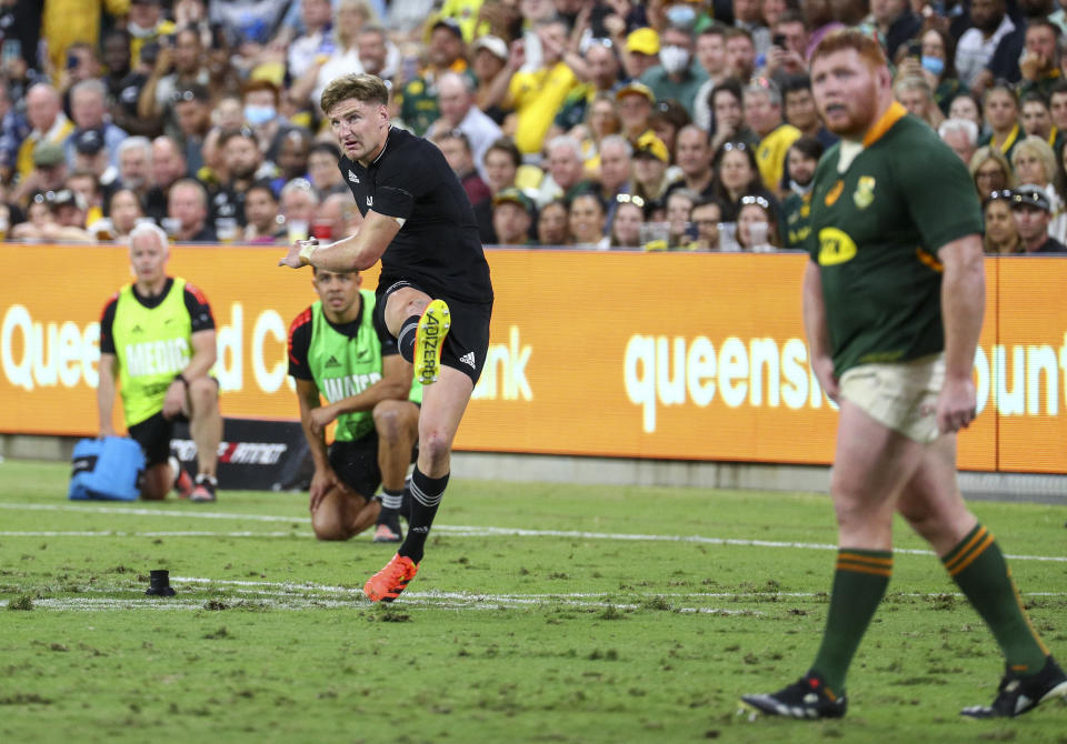 New Zealand's Jordie Barrett kicks the match winning penalty during the Rugby Championship test match between the Springboks and the All Blacks in Townsville, Australia, Saturday, Sept. 25, 2021. (AP Photo/Tertius Pickard)