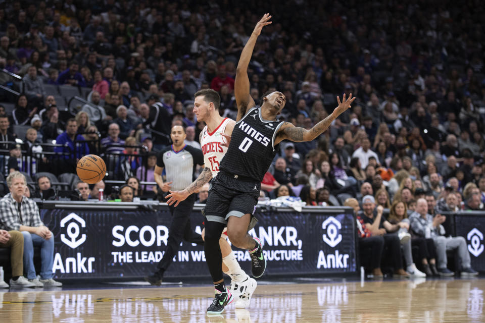 Houston Rockets guard Garrison Mathews (25) runs into Sacramento Kings guard Malik Monk (0) as they chased the ball during the second half of an NBA basketball game in Sacramento, Calif., Friday, Jan. 13, 2023. The Kings won 139-114. (AP Photo/José Luis Villegas)