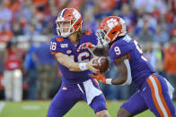 Clemson's Trevor Lawrence, left, hands the ball off to Travis Etienne during the first half of an NCAA college football game against Wofford, Saturday, Nov. 2, 2019, in Clemson, S.C. (AP Photo/Richard Shiro)