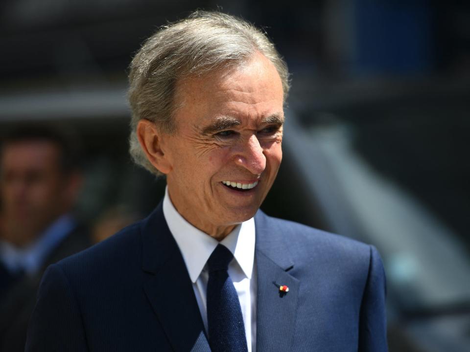 LVMH CEO Bernard Arnault smiles while standing outside