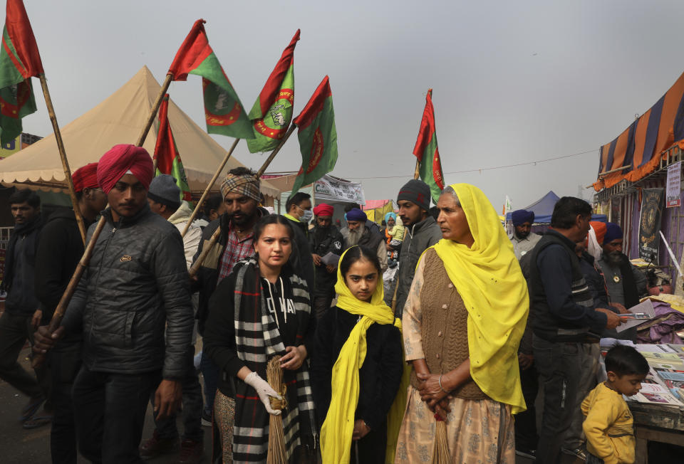 Manjeet Kaur, 60, right, stands for a photograph with her granddaughters as they arrive to participate in a protest against new farm laws at the Delhi-Haryana state border, on the outskirts of New Delhi, India, Sunday, Dec. 27, 2020. “I have never been in a protest before, but I would happily die for my land and for my future generation,” said Kaur. “We will fight for our rights.” From students, teachers and nurses to housewives and grandmothers, women are now holding the front lines at the massive protests that have blockaded key highways leading to India's capital for more than a month, demanding the repeal of new farm laws. (AP Photo/Manish Swarup)