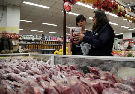 Members of the Public Health Surveillance Agency collect meats to analyse in their laboratory, at a supermarket in Rio de Janeiro, Brazil, March 20, 2017. REUTERS/Ricardo Moraes