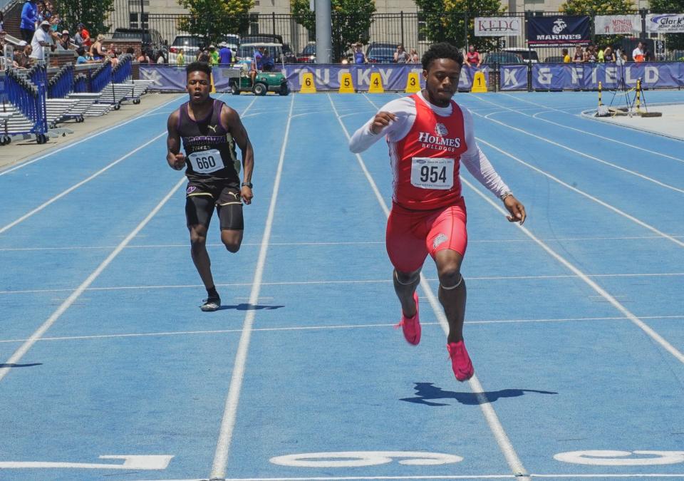 Holmes senior Curtez Hill crosses the finish line of the 200 meters in second place at the KHSAA Class 2A track and field championships at the University of Kentucky on June 2, 2023.