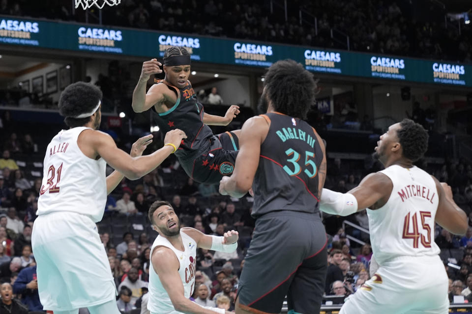 Washington Wizards guard Bilal Coulibaly (0) falls off balanced as he is charged with an offensive foul against Cleveland Cavaliers during the first half of an NBA basketball game in Washington, Tuesday, Feb. 25, 2025. (AP Photo/Manuel Balce Ceneta)