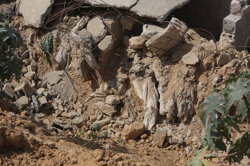 Dead bodies pictured in the cemetery after it was destroyed by the Israeli army during its incursion into the eastern part of Khan Yunis after withdrawing from it. Abed Rahim Khatib/dpa