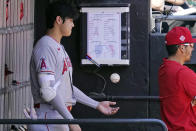 Los Angeles Angels designated hitter Shohei Ohtani, of Japan, plays with a ball in the dugout during the second inning of a baseball game against the Chicago White Sox in Chicago, Thursday, Sept. 16, 2021. (AP Photo/Nam Y. Huh)