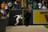 A Baltimore City Police officer chases a fan who ran onto the field during the Boston Red Sox and Baltimore Orioles game at Oriole Park at Camden Yards on September 26, 2011 in Baltimore, Maryland. (Photo by Rob Carr/Getty Images)