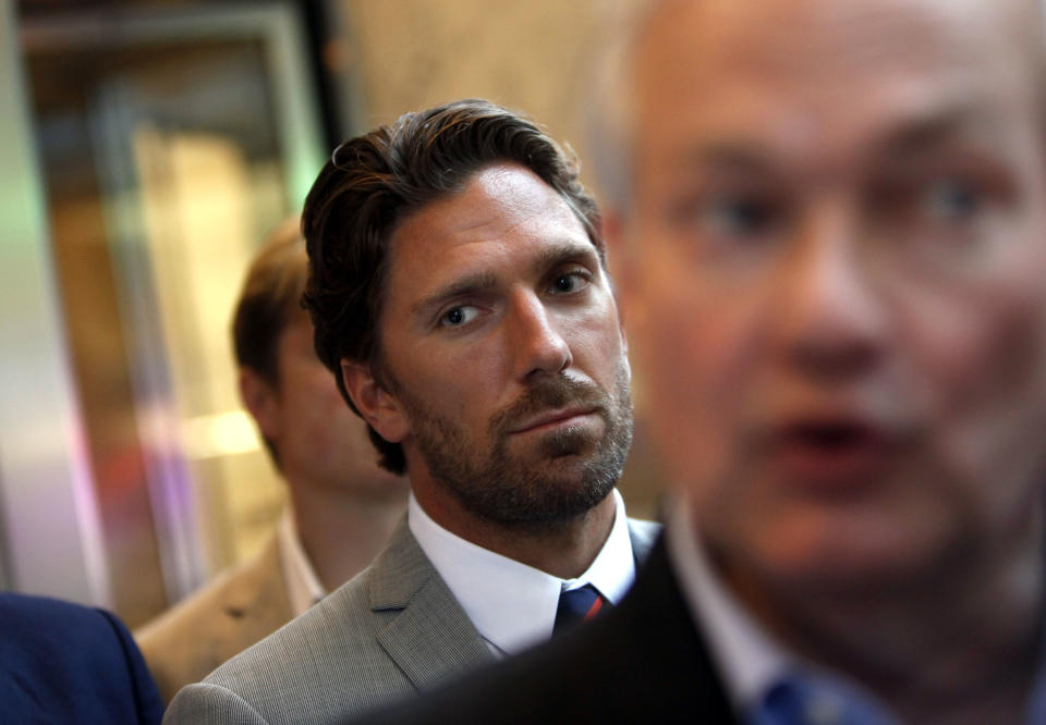 Hockey player Henrik Lundqvist looks on as NHL Players' Association Executive Director Donald Fehr, right, speaks to reporters after a negotiation session between the players' union and the NHL, Wednesday, July 18, 2012, in New York. (AP Photo/Jason DeCrow)