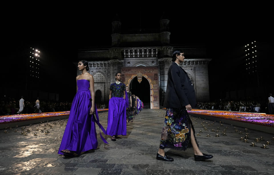 Models display creations for the Dior Pre-Fall 2023 collection at the Gateway of India landmark monument in Mumbai, India, Thursday, March 30, 2023. (AP Photo/Rafiq Maqbool)