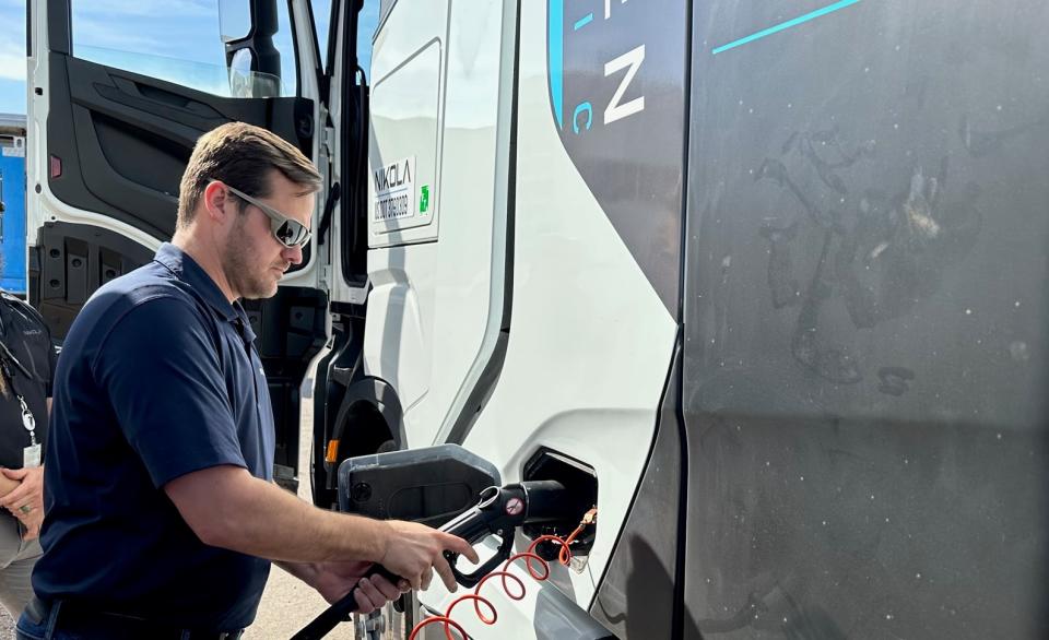 Nikola COO Brett Cook fills a hydrogen truck with fuel outside the Nikola plant in College, Arizona.  (Photo: Alan Adler/Free Waves)