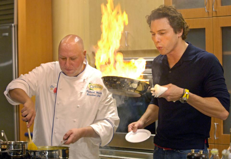 Celebrity chef Rocco DiSpirito blows out a flaming pan during a cooking demonstration with Publix chef Patrick Walley at the new Mandarin Publix on Thursday, Nov. 30, 2006, in Jacksonville.