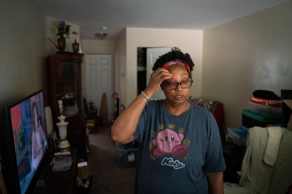 Tonya Hogan, 50, stands inside her apartment in Melvindale on Sunday, August 20, 2023. "I have always been the black sheep of the family," said Hogan, as she relived memories while looking through her belongings. "They weren't supporting me in the shelter, so why would I think they wouldn't do the same thing while I was here."