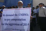 Palestinian demonstrators stand in front of the gate of the United Nations Relief and Works Agency (UNRWA), demanding that the agency fulfil promises to compensate them for losses to their homes during the 2014 war, in Gaza City, Thursday, Sept. 7, 2023. The protest revealed public desperation amid ongoing efforts to alleviate Gaza's housing crisis, including an Egyptian-funded project that aims to complete 1,400 apartments by the end of this year. (AP Photo/Adel Hana)