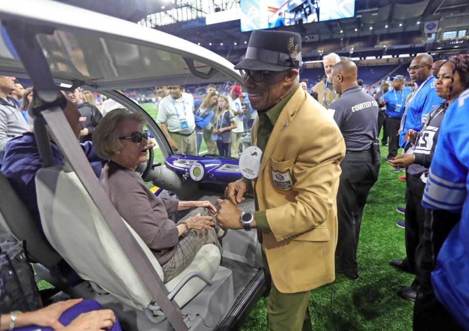 Former Detroit Lions owner Martha Ford and Lions Hall of Famer Lem Barney on the field before the game at Ford Field on Sunday, Sept. 29, 2019.