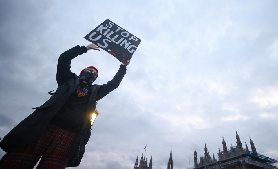 A woman holds a placard during the protest in London on Monday.