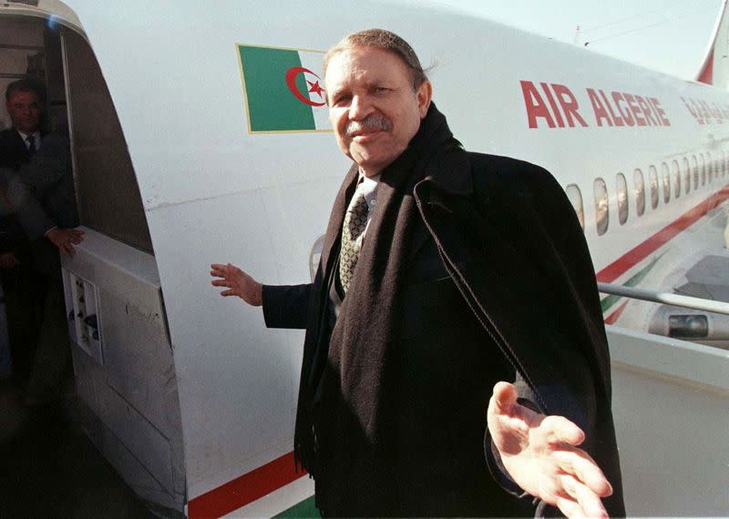 FILE PHOTO: Algerian Presidential candidate Abdelaziz Bouteflika waves while boarding an aircraft during a campaign visit to the southern Algerian town of Tamanrasset