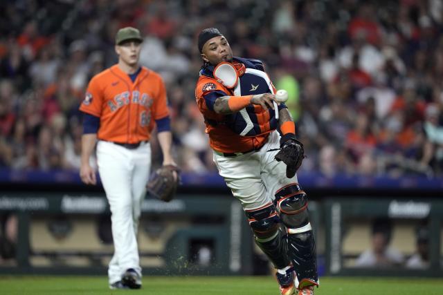 Houston Astros catcher Martin Maldonado throws to first after fielding a single by Oakland Athletics' Jace Peterson during the sixth inning of a baseball game Friday, May 19, 2023, in Houston. (AP Photo/David J. Phillip)