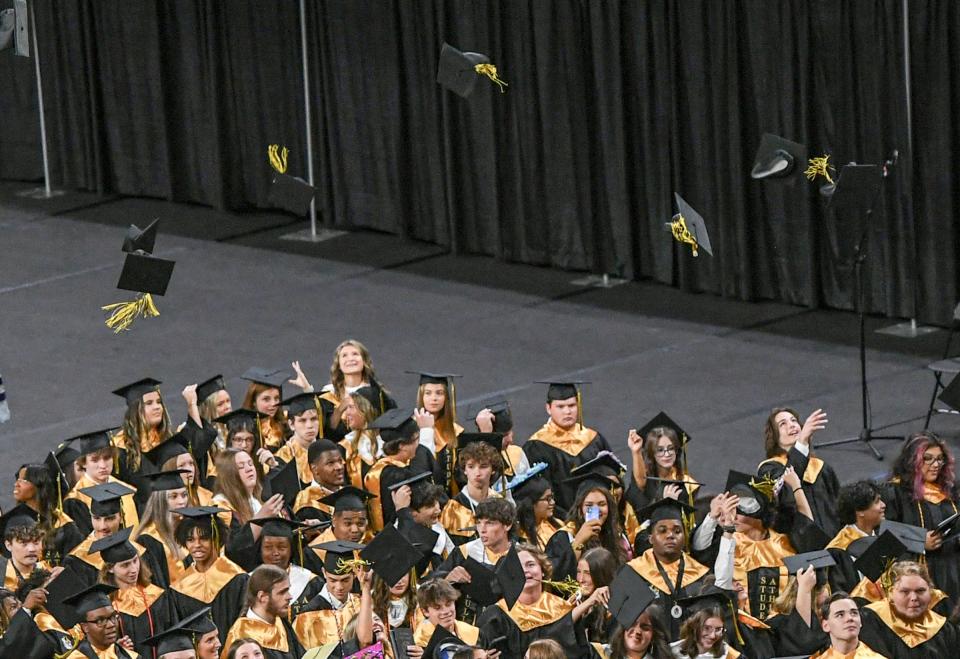 Graduates toss their caps during the 2024 ceremony for Pendleton High School in Littlejohn Coliseum in Clemson, S.C. Tuesday, May 21, 2024.