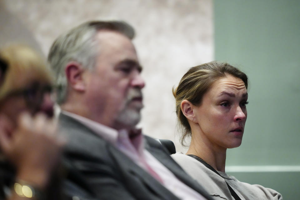 Philadelphia Eagles' Jason Kelce's wife, Kylie McDevitt Kelce, listens to him speak during an NFL football press conference announcing his retirement in Philadelphia, Monday, March 4, 2024. (AP Photo/Matt Rourke)