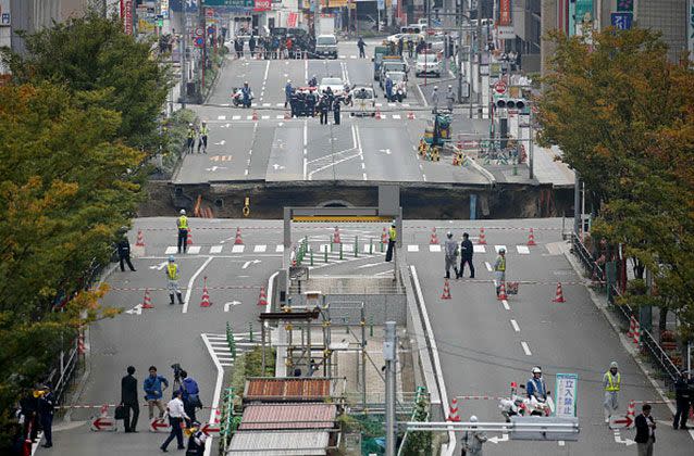 A large sinkhole cuts off an avenue in central Fukuoka, southwestern Japan. Picture: Getty