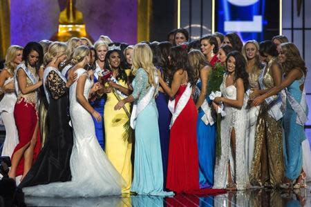 Miss America contestant, Miss New York Nina Davuluri (in yellow) celebrates with other contestants after being chosen winner of the 2014 Miss America Pageant in Atlantic City, New Jersey, September 15, 2013. REUTERS/Lucas Jackson