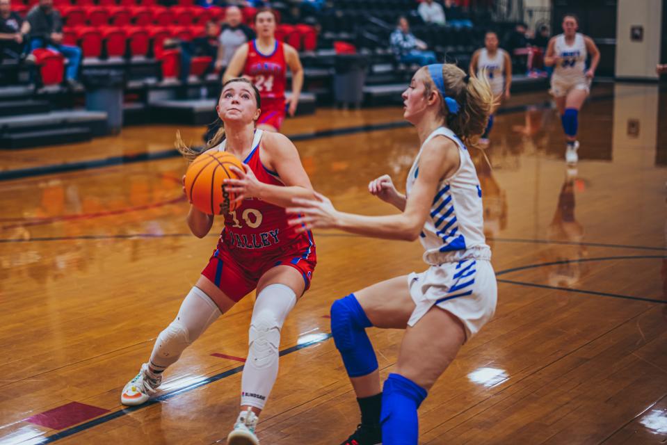 Caney Valley's Saige Scott goes in for a layup on Liberty's Jennika Boone during Thursday night's game.