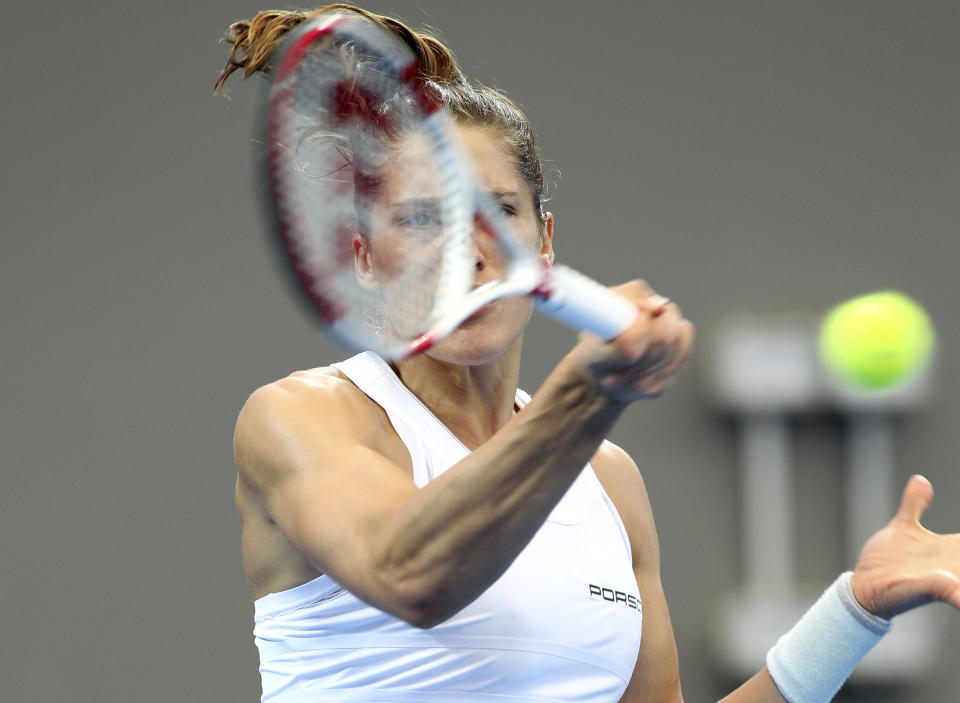 Andrea Petkovic of Germany plays a shot during her match against Samantha Stosur of Australia during the Fed Cup semifinals between Australia and Germany in Brisbane, Australia, Saturday, April 19, 2014. (AP Photo/Tertius Pickard)