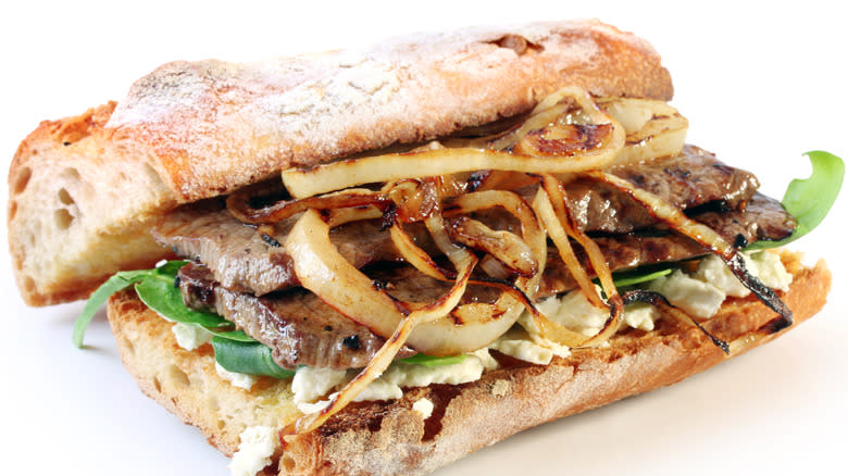 Steak ciabatta sandwich with caramelized onion and goat cheese