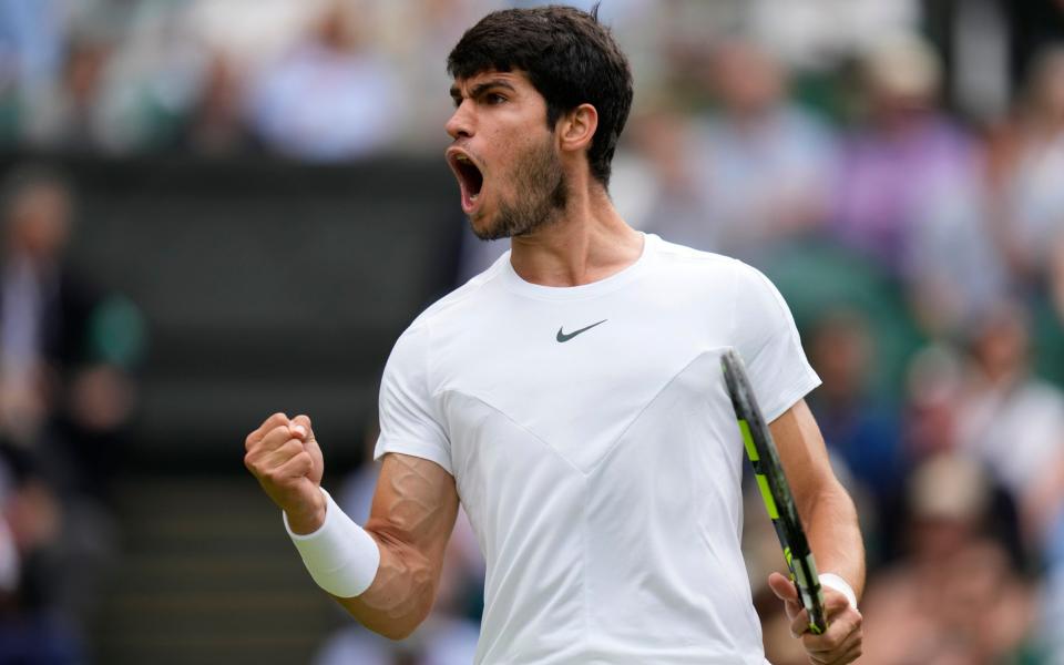 Spain&#39;s Carlos Alcaraz reacts as he wins a point against Denmark&#39;s Holger Rune in a men&#39;s singles match on day ten of the Wimbledon tennis championships in London