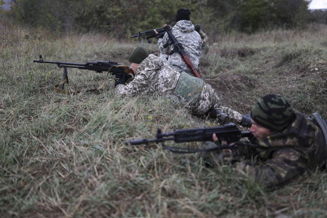 FILE - Recruits hold their weapons during military training at a firing range in the Krasnodar region in southern Russia, Friday, Oct. 21, 2022. A campaign to replenish Russian troops in Ukraine with more soldiers appears to be underway again, with makeshift recruitment centers popping up in cities and towns, and state institutions posting ads promising cash bonuses and benefits to entice men to sign contracts enabling them to be sent into the battlefield. (AP Photo, File)