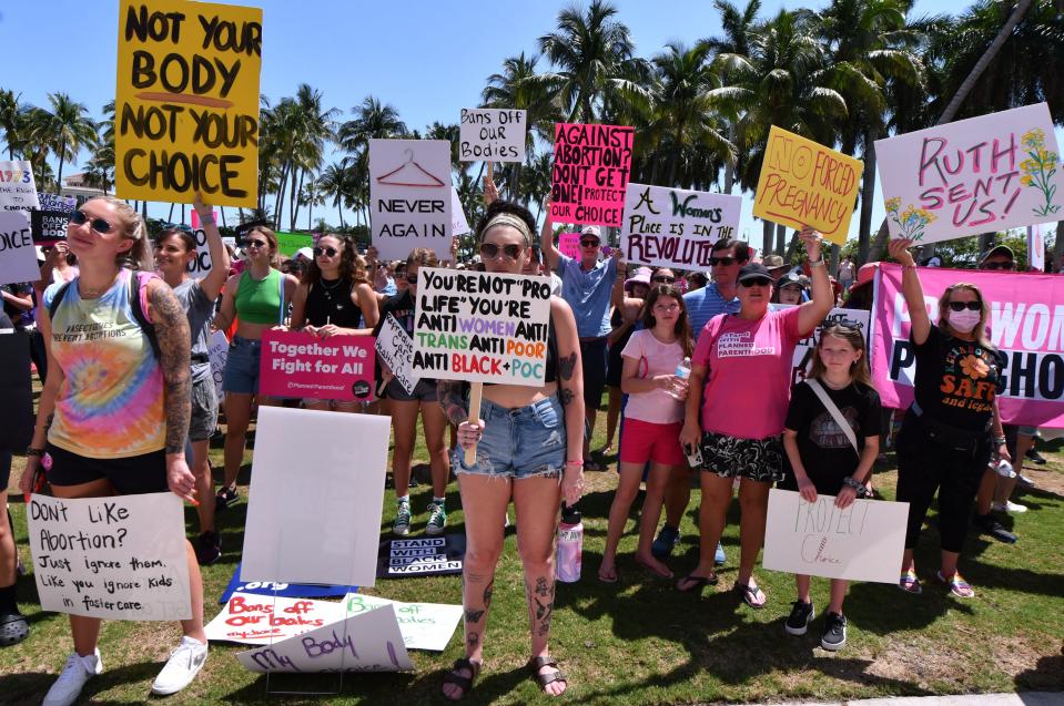 People attend an abortion-rights rally and march sponsored by the League of Women Voters held at the Meyer Amphitheater in downtown West Palm Beach on Saturday, May 14, 2022.