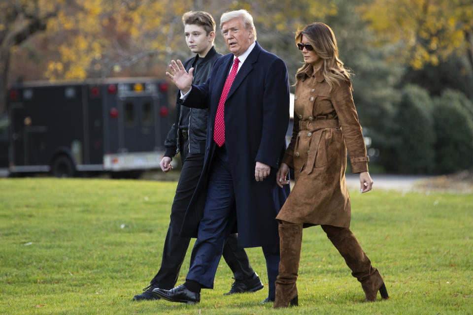 FILE- In this Nov. 26, 2019, file photo, President Donald, first lady Melania Trump, and Barron Trump, walk to board Marine One on the South Lawn of the White House, in Washington. Melania Trump is quietly forging her way through President Donald Trump&#39;s impeachment. (AP Photo/ Evan Vucci, File)