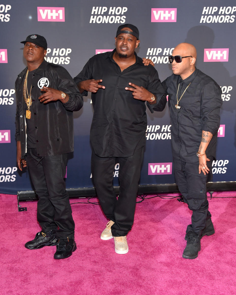 American rappers The LOX wearing black posing for a picture on the red carpet.