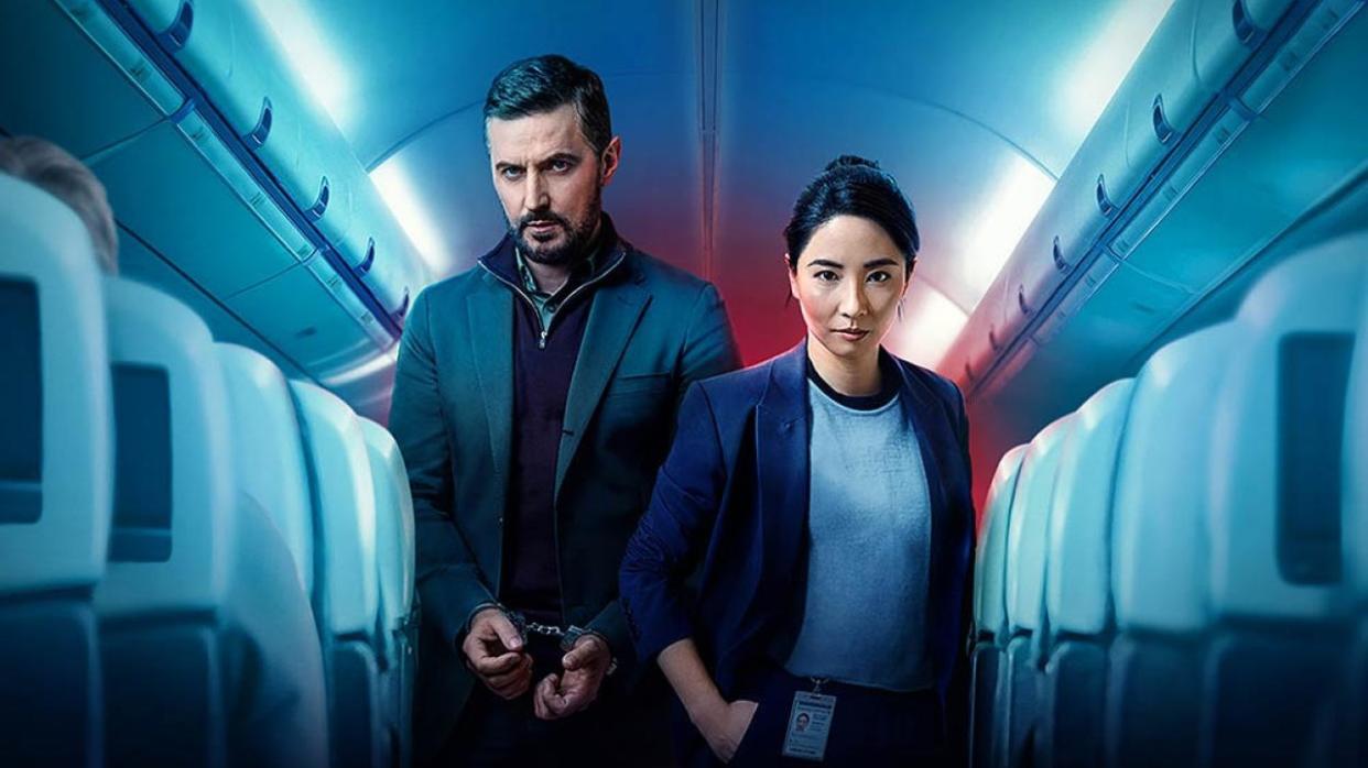  Dr Matthew Nolan (Richard Armitage), in handcuffs, stands behind DC Hana Li (Jing Luci) aboard an passenger plane in Red Eye. 